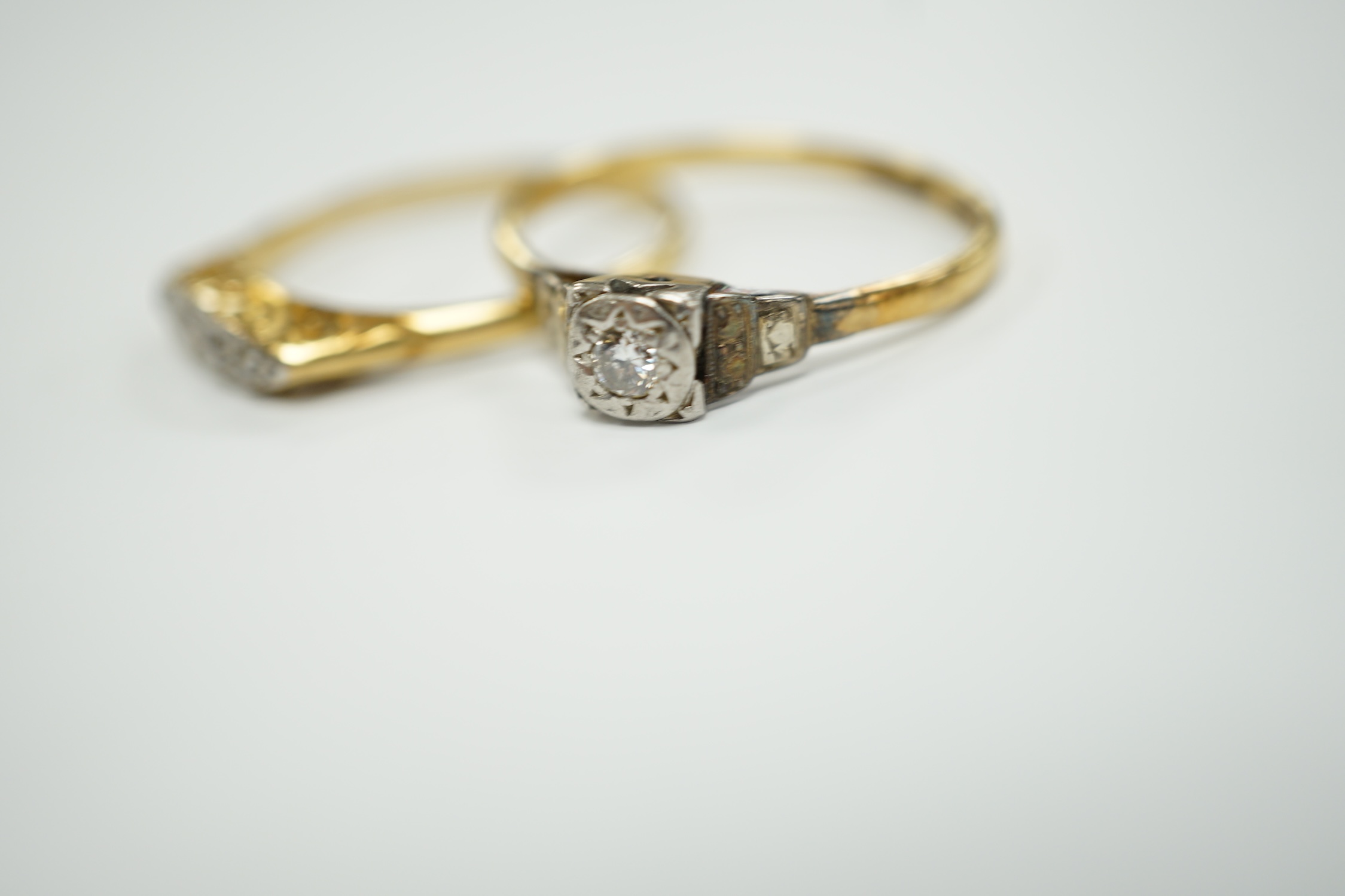 Two early to mid 20th century 18ct, plat and diamond set rings, including graduated five stone, gross weight 7.8 grams.
